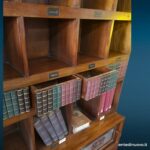 Libreria inglese in teak con cassetti e ante scorrevoli