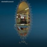 Specchiera ovale anni 50 Pierluigi Colli in ferro martellinato con mensola