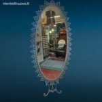 Specchiera ovale anni 50 Pierluigi Colli in ferro martellinato con mensola