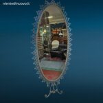 Specchiera ovale anni 50 Pierluigi Colli in ferro martellinato con mensola