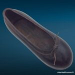 Scarpina soprammobile in ferro brunito a forma di scarpa da bambina con laccetto metallico, fermacarte vintage anni Trenta